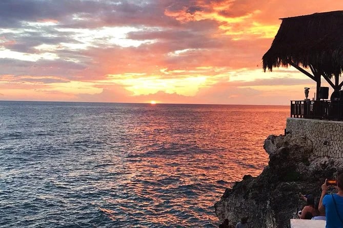 Watching Sunsets On A Cliff